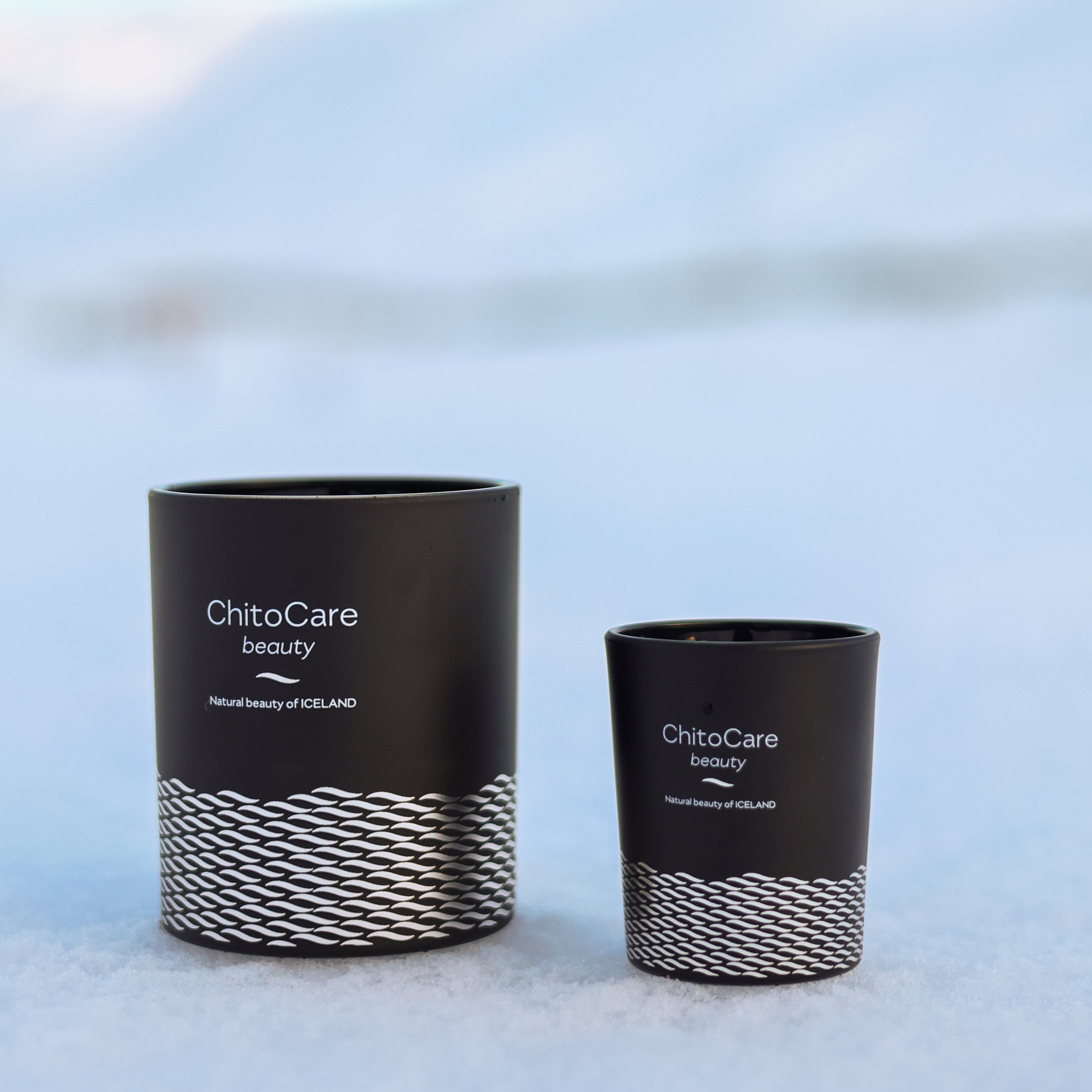 Two black cylindrical containers with 'ChitoCare beauty' branding on a snowy background